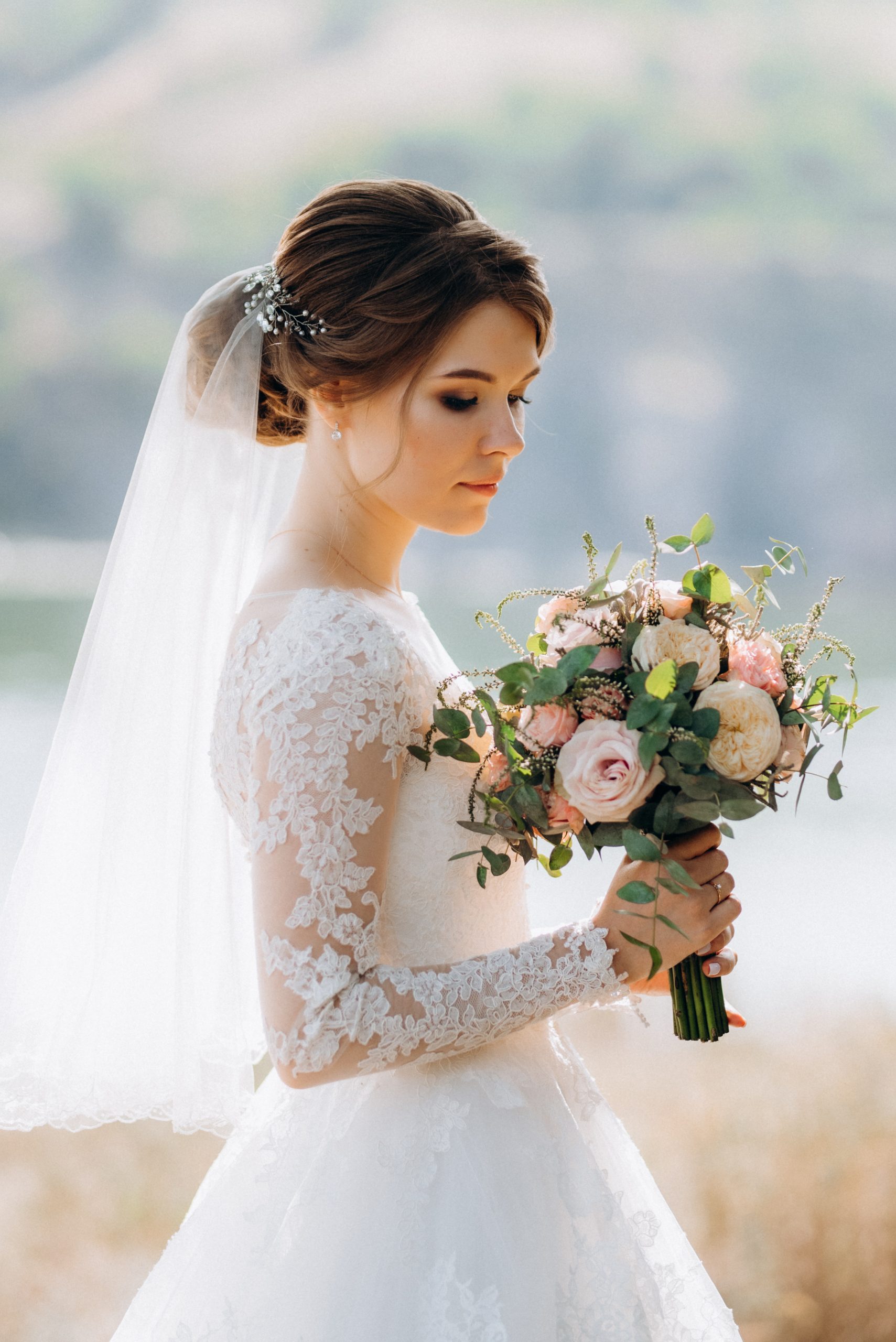 bride blonde girl with a bouquet in the forest